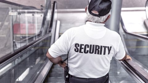 Security guard going down escalator