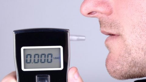 Man using breath tester machine