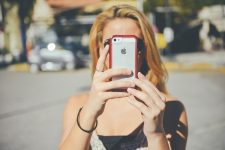 Girl holding up smartphone