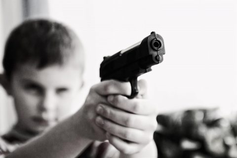 Boy pointing gun