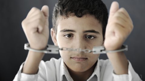 Young boy in handcuffs