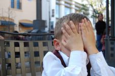 Child covering his face