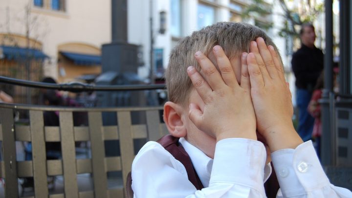 Child covering his face