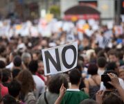 Protesters and a no sign