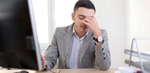 Male employee stressed at work