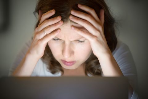 Stressed woman on laptop