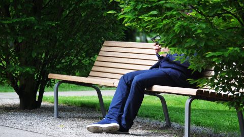 Hidden identity man sitting on bench