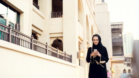 Muslim woman on her mobile phone
