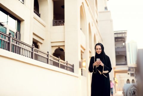 Muslim woman on her mobile phone