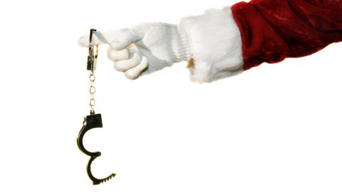 Santa holding handcuffs