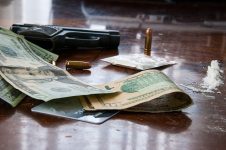 Gun, money, and cocaine on a table