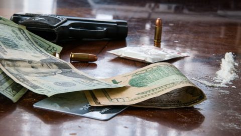 Gun, money, and cocaine on a table