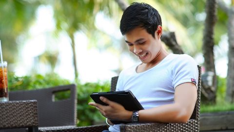 Happy man on his ipad