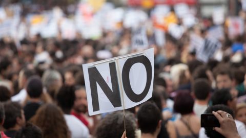 Protesters with a no sign