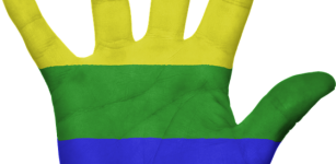 Gay flag painted on a hand