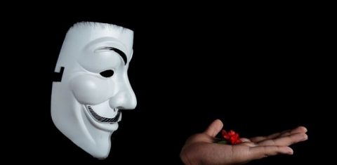 Anonymous holding a red flower