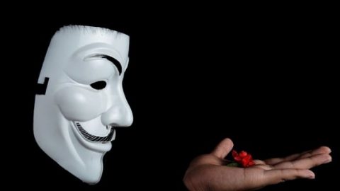 Anonymous holding a red flower