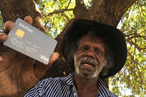 Man displaying a cashless debit card