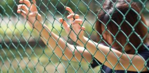 Woman prisoner at fence