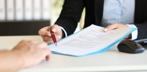 Woman lawyer giving contract to client
