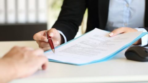 Woman lawyer giving contract to client