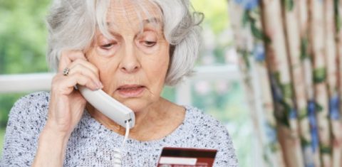 Elderly woman on phone to a scammer