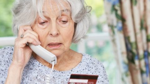 Elderly woman on phone to a scammer