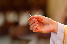 Catholic priest holding communion