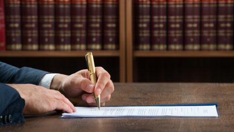 Lawyer writing with a pen