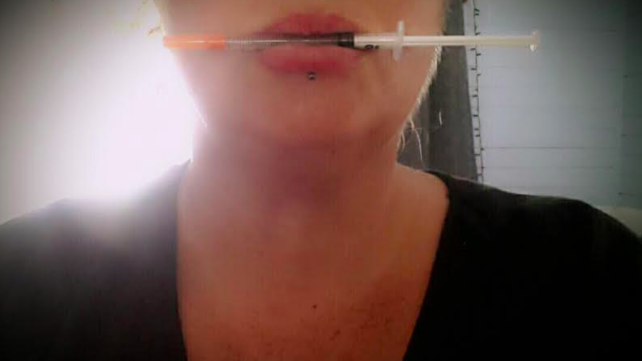 Woman with drug syringe