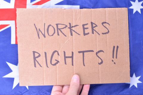 Worker Rights sign in front of an Australian flag