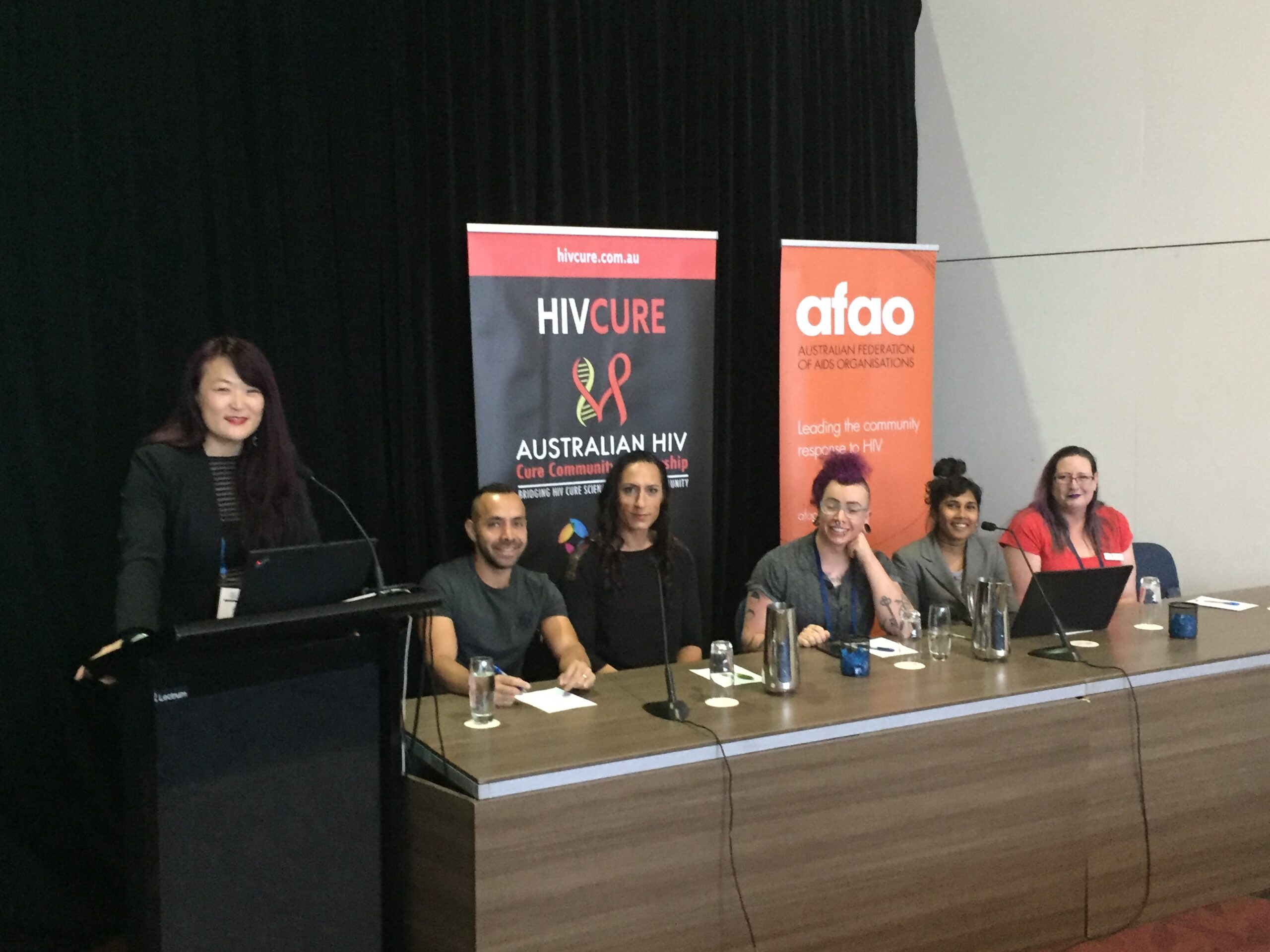 Scarlet Alliance CEO Jules Kim at the podium addressing a HIV seminar
