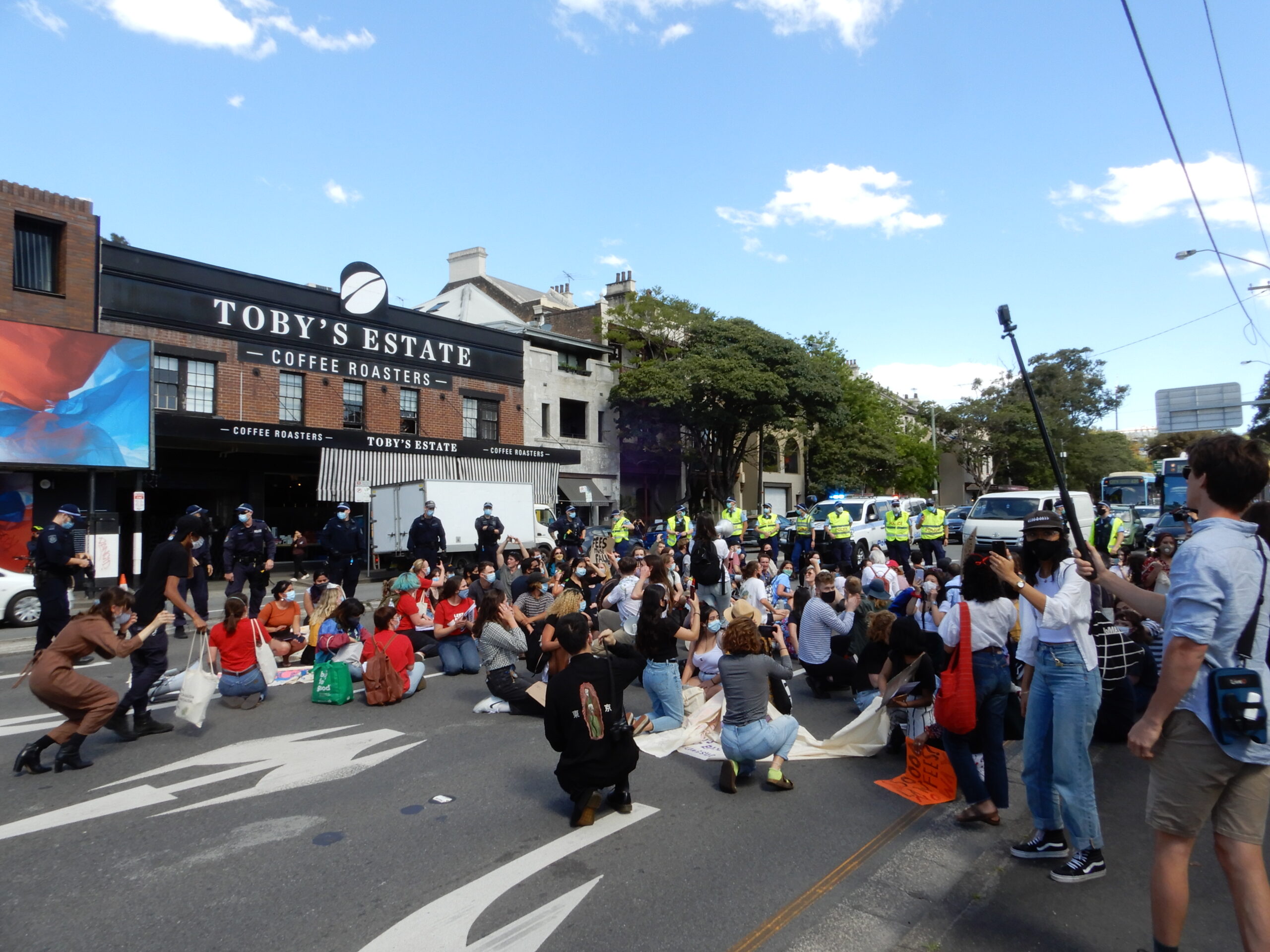 Demonstrators occupy the road as NSW police turn up in droves