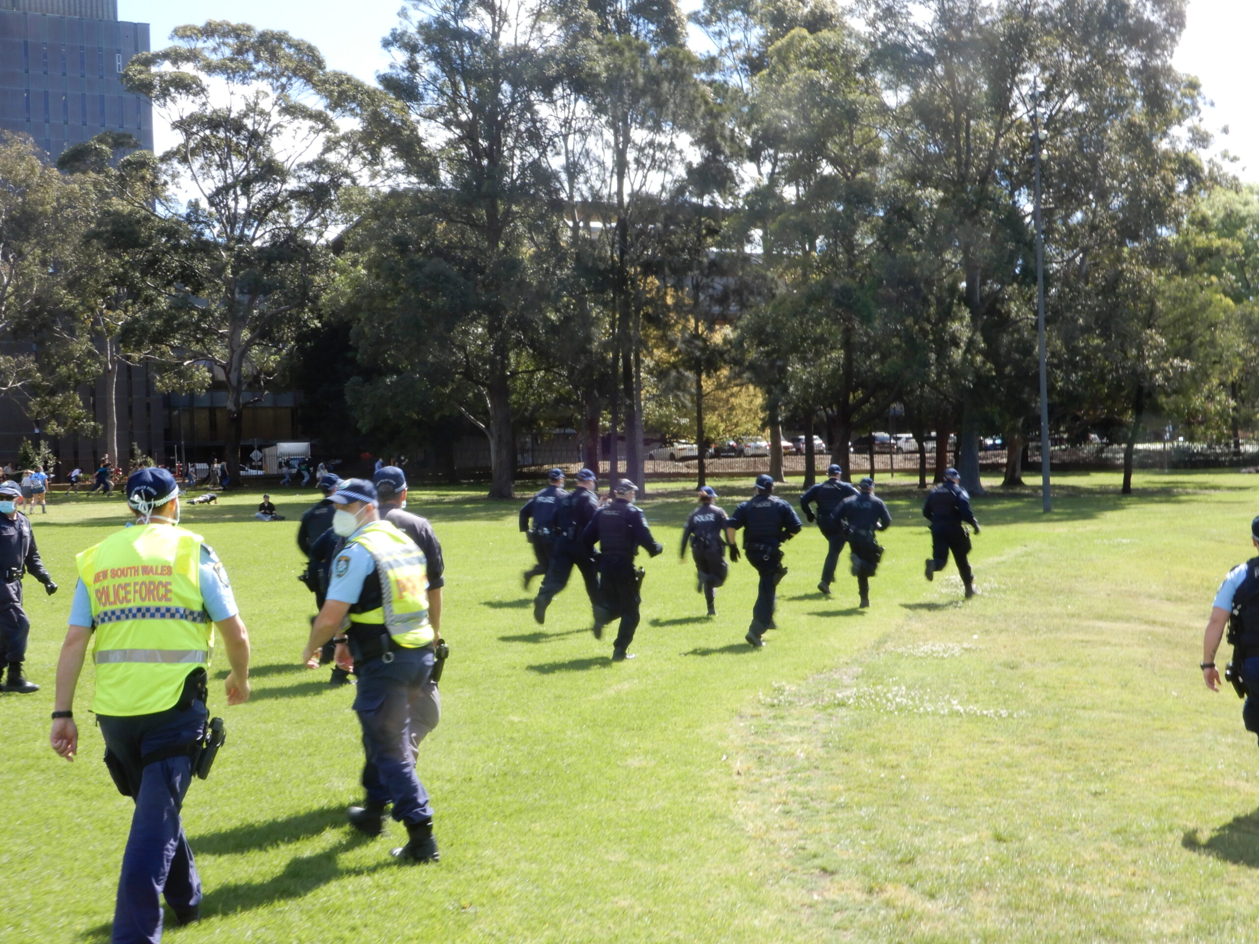 Police race across Victoria Park in an attempt to head off students