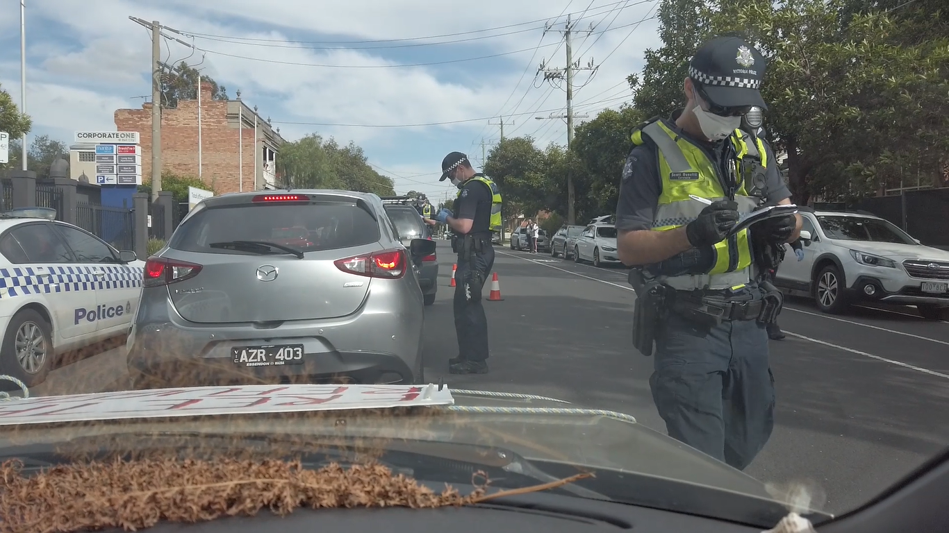 Police fining car convoy demonstrators in April 2020