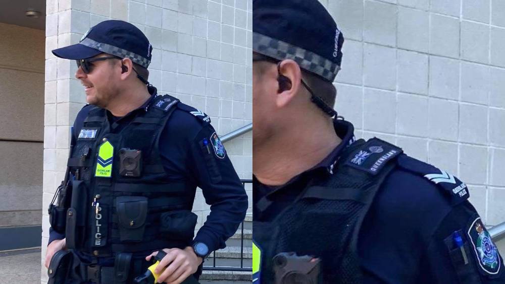 Queensland police officer wearing a thin blue line patch upon his shoulder at the Disrupt Land Forces demonstrations