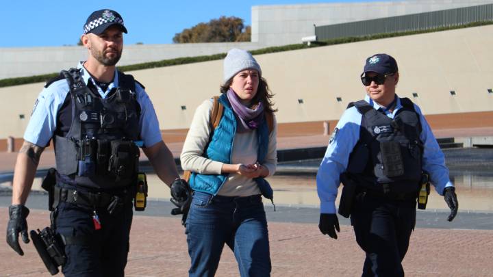 Violet is led away by police on 10 August