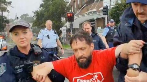 A Fireproof Australia activist being dragged away by police in Brighton-Le-Sands last Tuesday