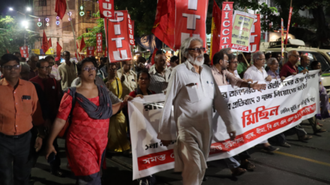 TET protester Sangita Sharma marches in front holding the edge of the banner