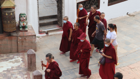 Tibetan monks and nuns conducting their daily kora, or circumnavigation of the shrine