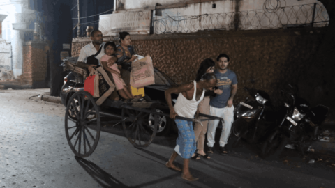 A whole family rides carrying bags of goods after a tough day of shopping