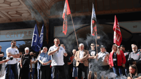 Maritime Workers Union Sydney branch secretary Paul Keating speaks before a line of union representatives