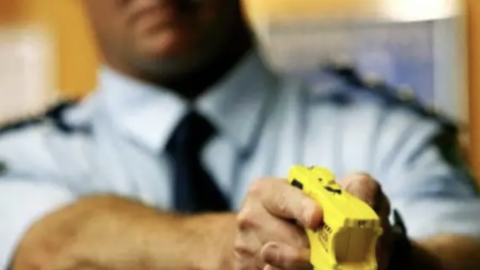 Taser held by a man