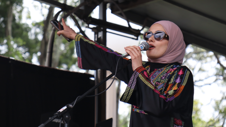 Palestine Action Group Sydney spokesperson Assala Sayara leads the ralliers in chants