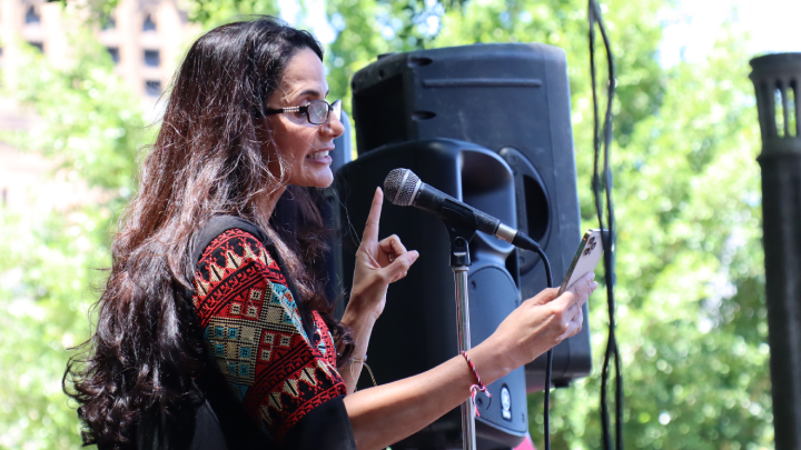 Palestinian woman Reem Burrows address the rally in Hyde Park North