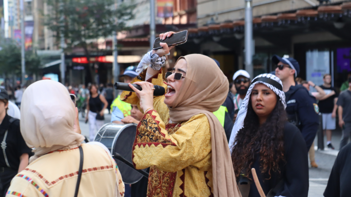 Palestinian orator Assala Sayara leads the procession for Palestinian liberation