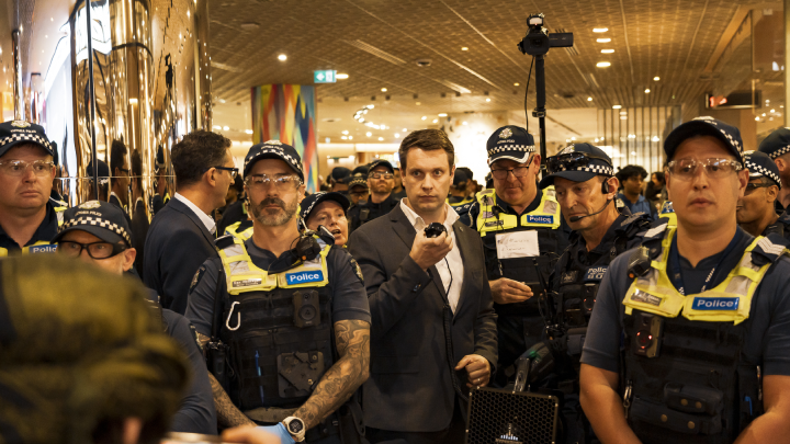 Victoria police officers were enthused by the late afternoon Melbourne Central demonstration after spending the day running around after the antigenocide demonstrators. Photo credit Matt Hrkac