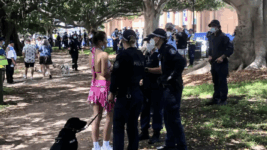 Police quizzing Field Day 2022 patron on New Year’s Day. Photo credit: Unharm employee Bruce Knobloch