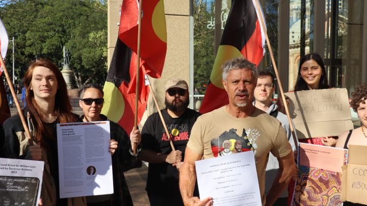 Wiradjuri man Paul Towney out the front of the Federal Court of Australia on Gadigal land in Sydney. He is surrounded by his supporters