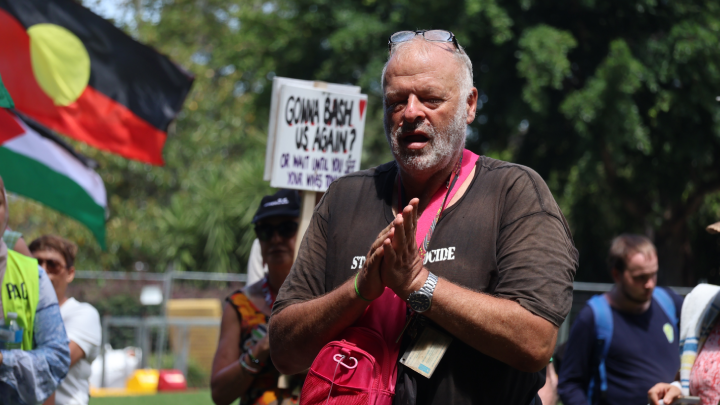 Social justice activist Stephen Langford listening to speakers in the park Social justice activist Stephen Langford listening to speakers in the park